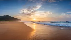 A panoramic view of Navsari Beach at sunrise, with the golden light gently illuminating the